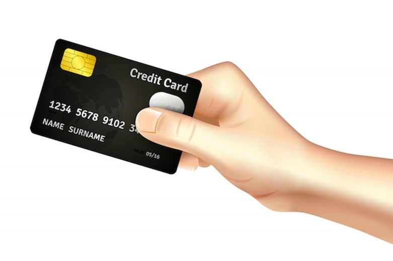 A hand holding a credit card